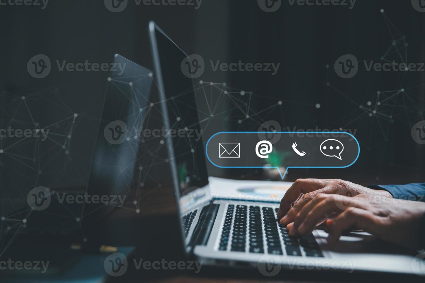 Customer support hotline contact us people connection concept. Web page online customer service technology idea. Businesswoman using computer with email, call phone, address, Chat message icons. photo
