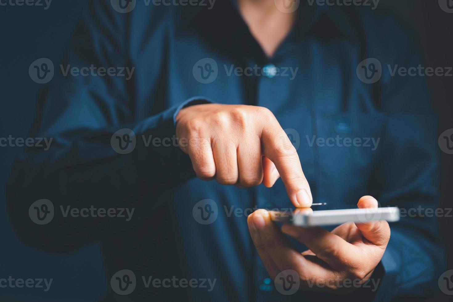 Closeup of businesswoman hand on empty dark blue background in office for design work, insert icon bundle or business technology symbols or other. selective focus on hand. female online working photo
