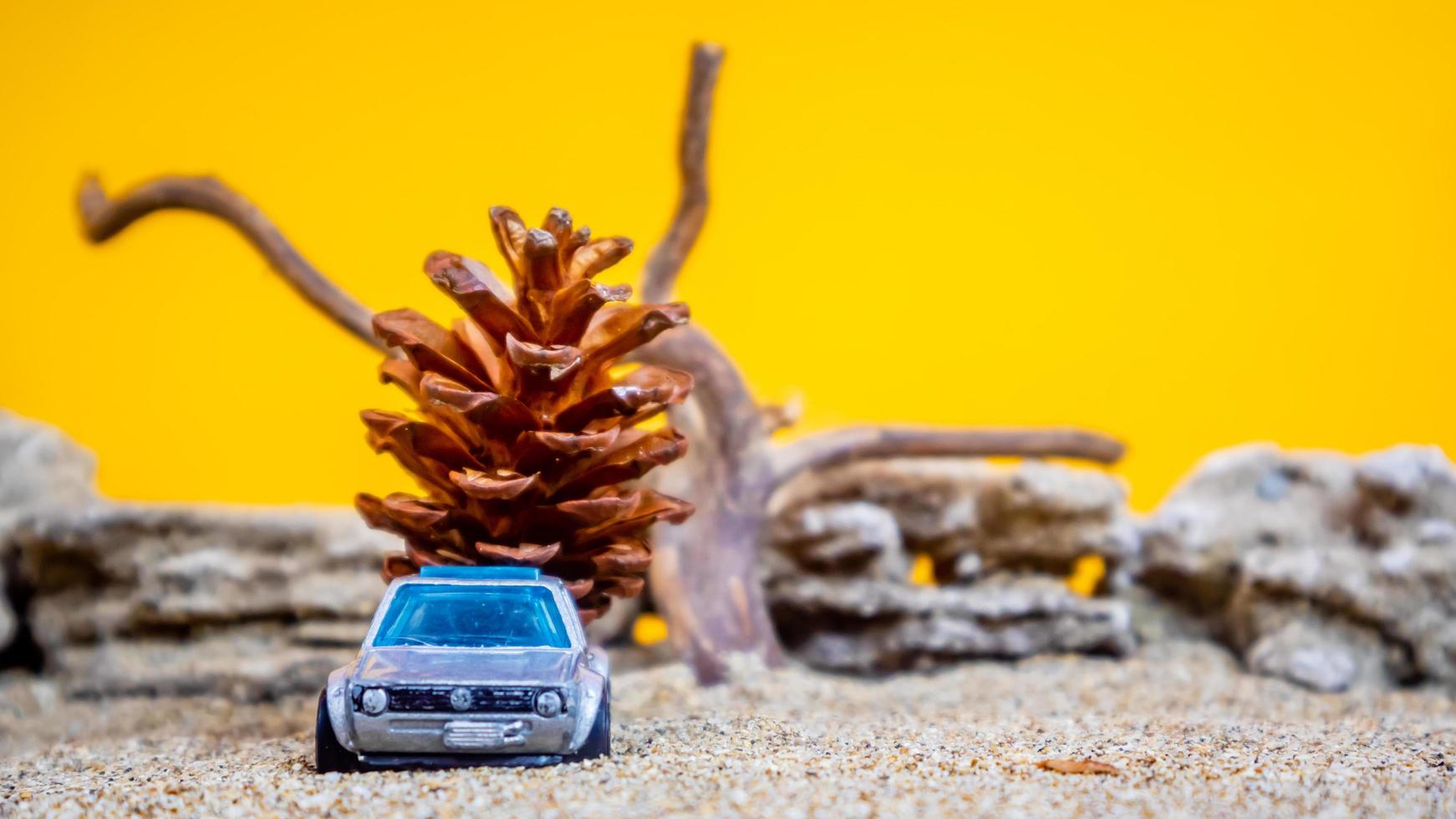 toy car hauling pinecones on an orange background photo