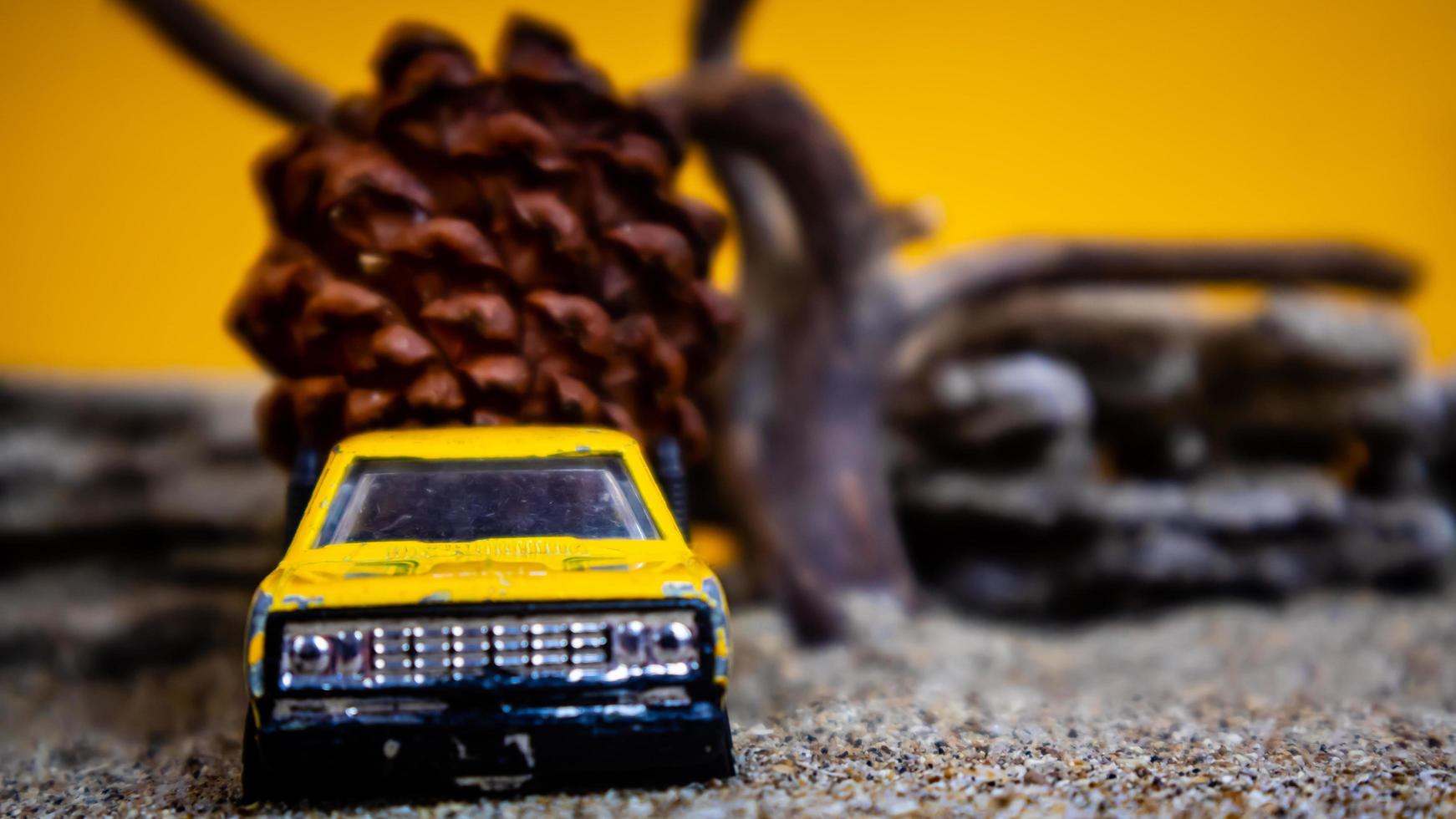 toy car hauling pinecones on an orange background photo