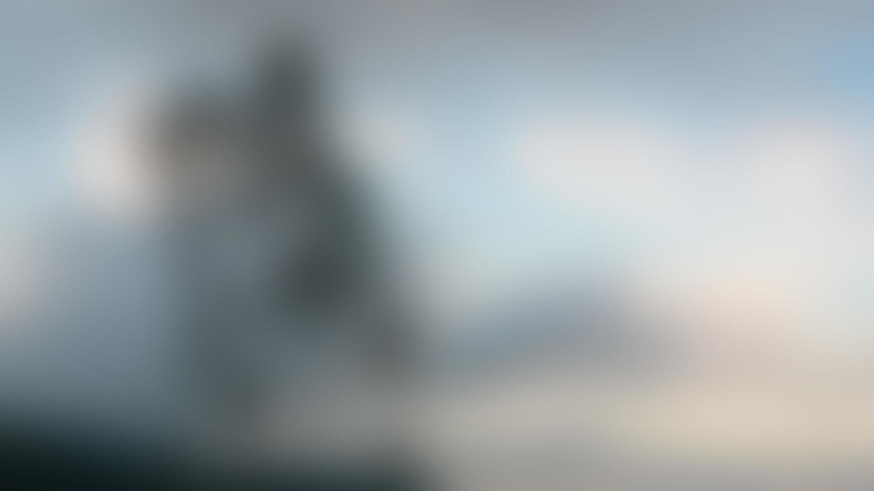 defocused tree on a hill with cloudy sky photo