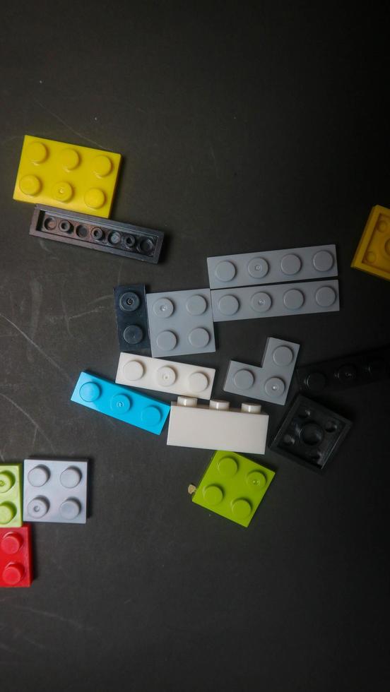 Plastic toy block on a black background photo