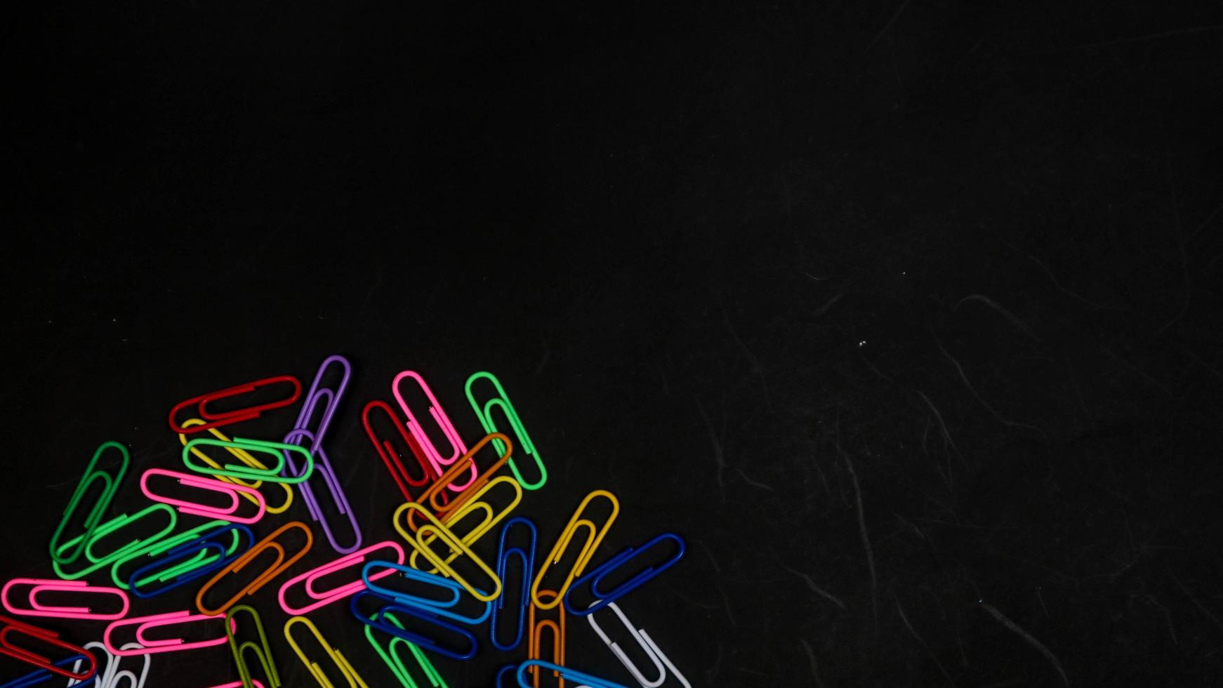 Paper clip isolated on a black background photo