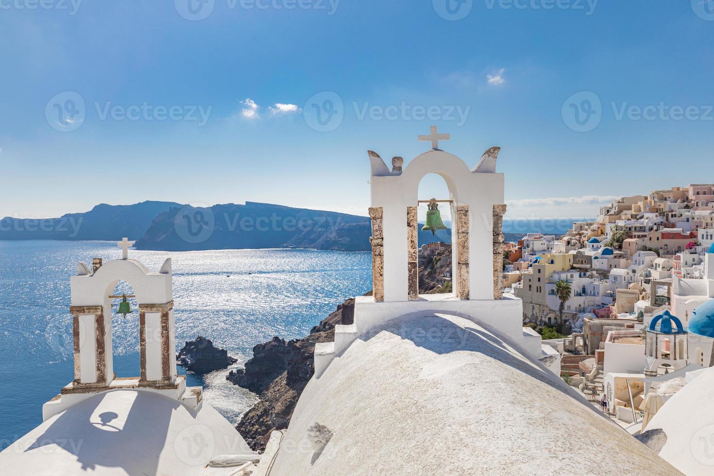 Amazing blue sky and beautiful view in Santorini, Greece. Old church and sea view in Greece. Perfect white architecture in famous vacation destination with Oia village in the background photo