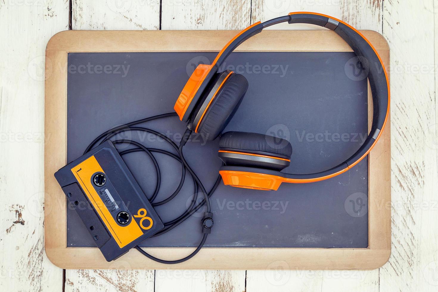 vintage audio cassettes and headphones over a black chalkboard photo