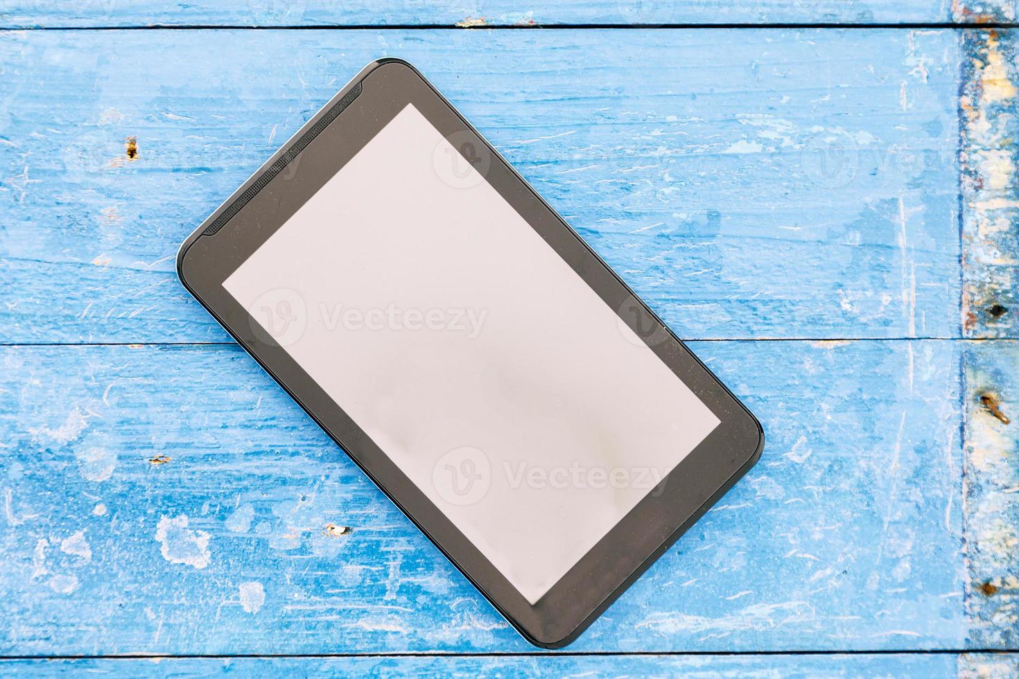 smartphone with clean screen on a blue wood background photo