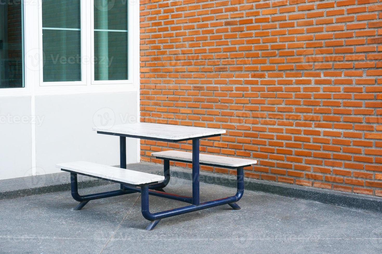 Bench in front of a brick wall blocks at modern building photo