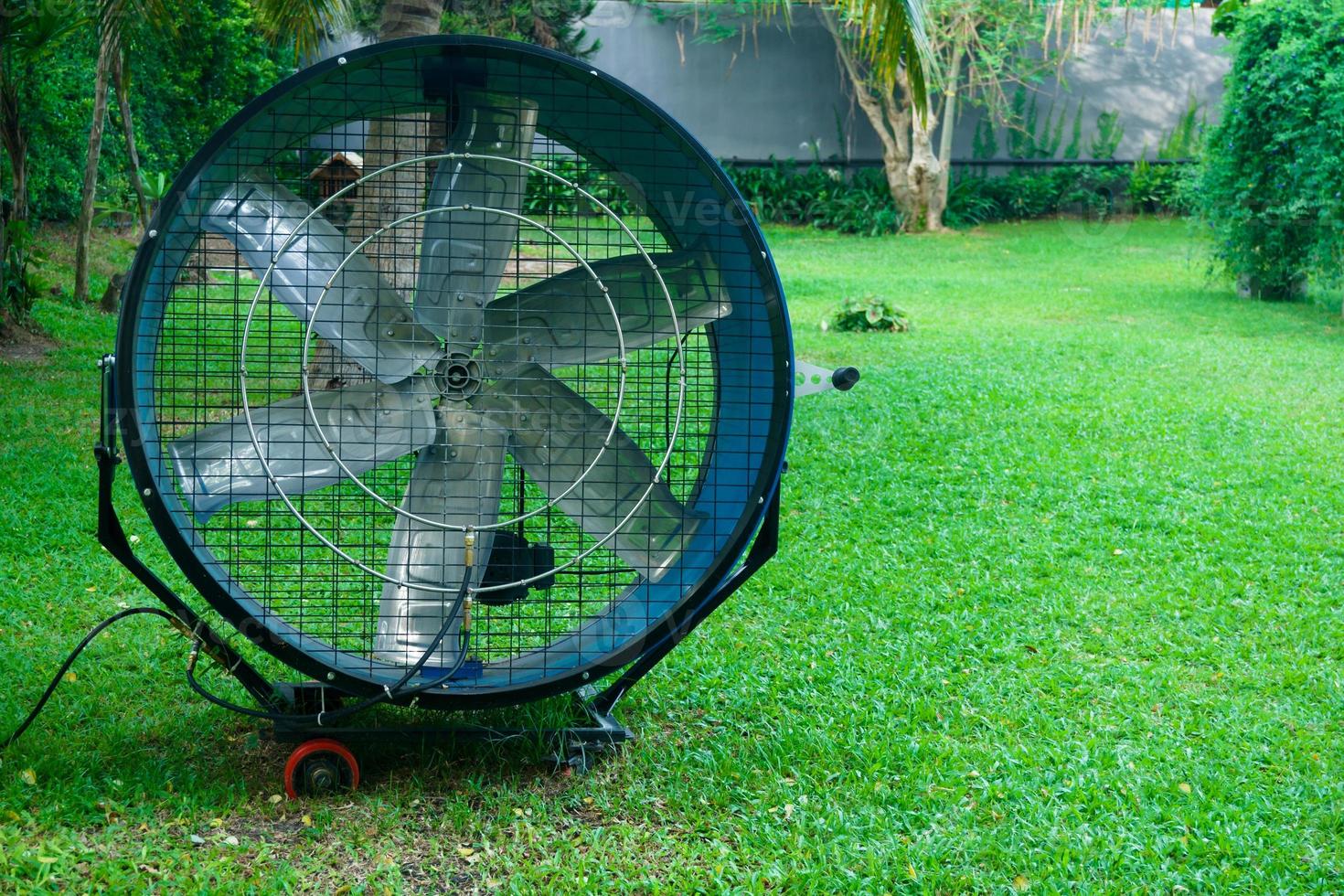 Large round powerful industrial professional metal iron fan with louvres at garden photo