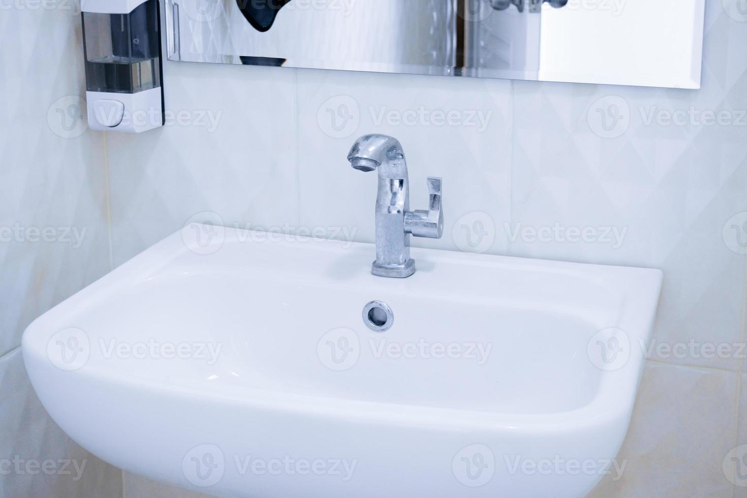 Interior of public clean toilet white sink interior of public toilet with of washing hands and mirror photo