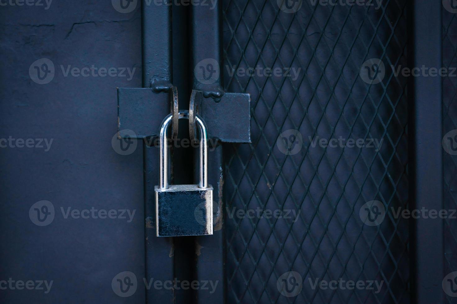 Closeup Locked Gate ,Padlock on a metal Iron gate. photo