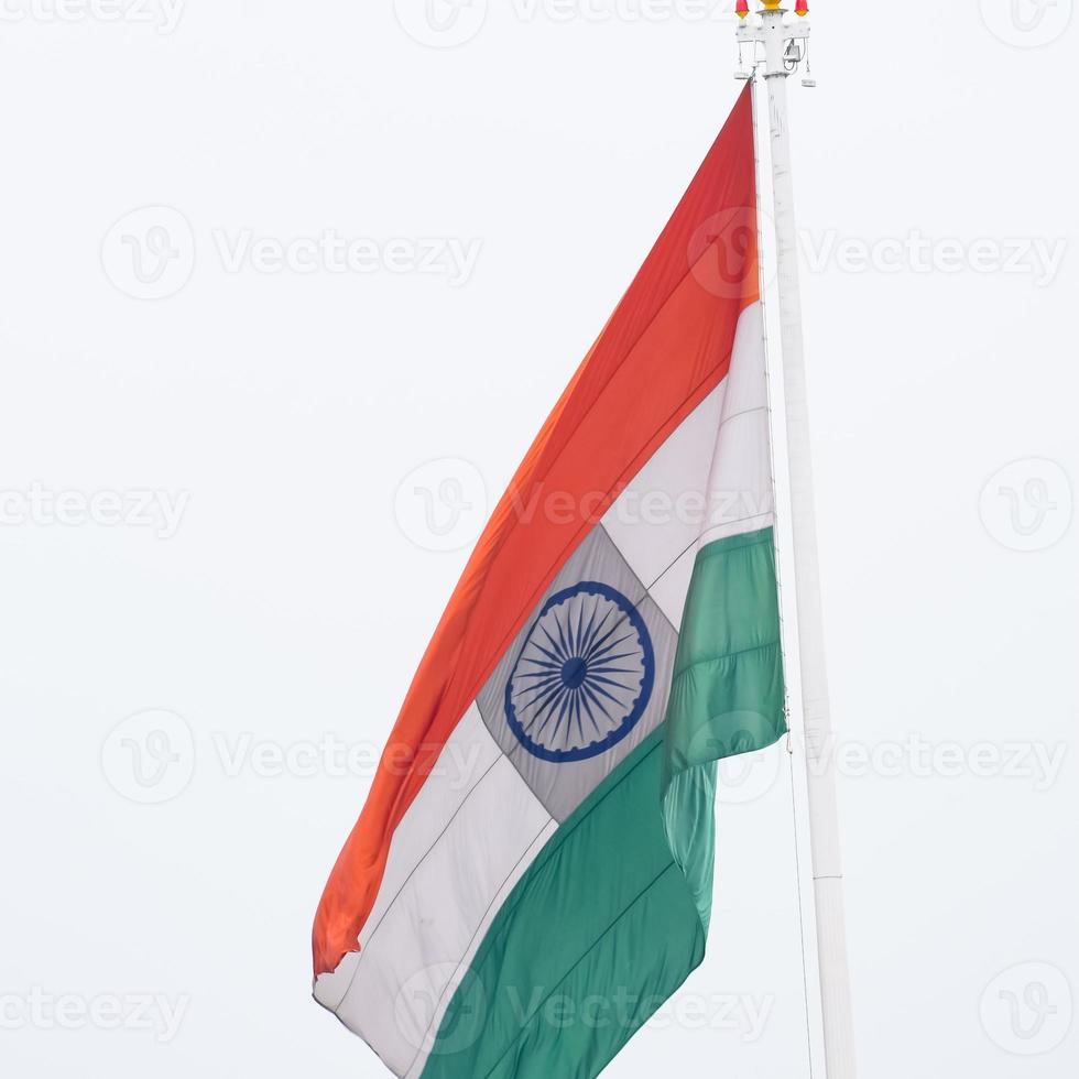 India flag flying high at Connaught Place with pride in blue sky, India flag fluttering, Indian Flag on Independence Day and Republic Day of India, tilt up shot, Waving Indian flag, Har Ghar Tiranga photo