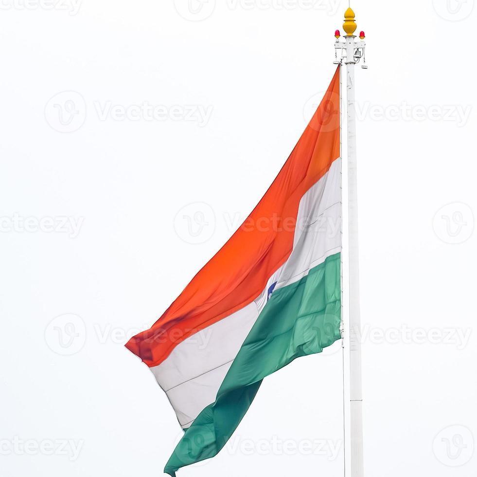 India flag flying high at Connaught Place with pride in blue sky, India flag fluttering, Indian Flag on Independence Day and Republic Day of India, tilt up shot, Waving Indian flag, Har Ghar Tiranga photo