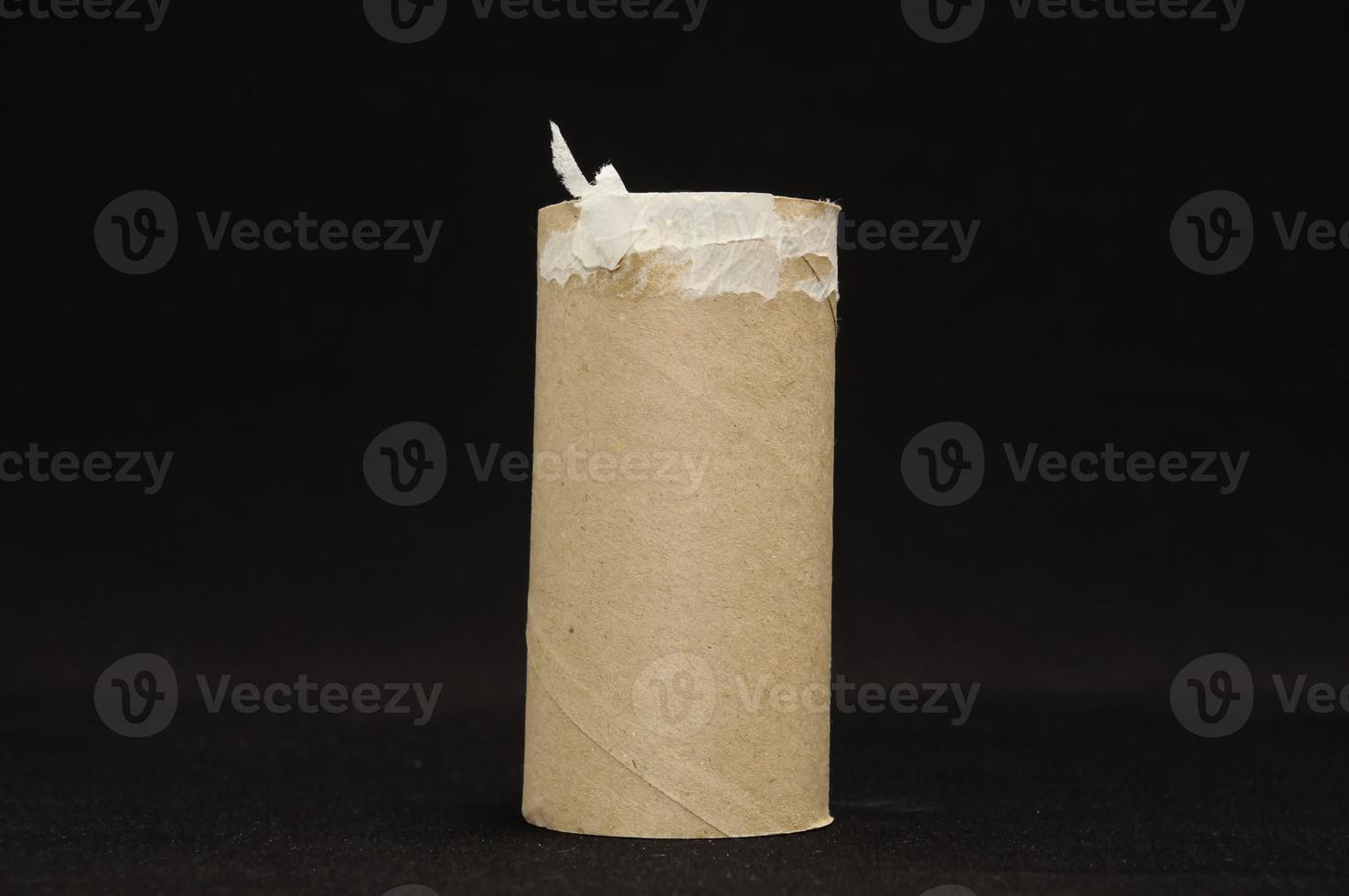 Empty toilet paper roll on black background photo