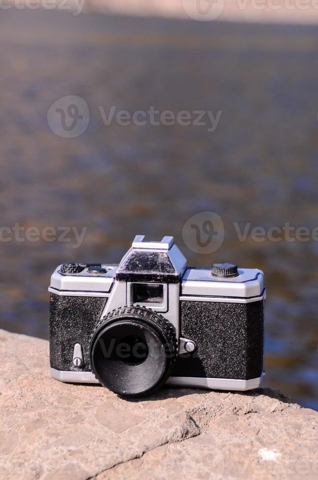 Vintage camera on the rock photo