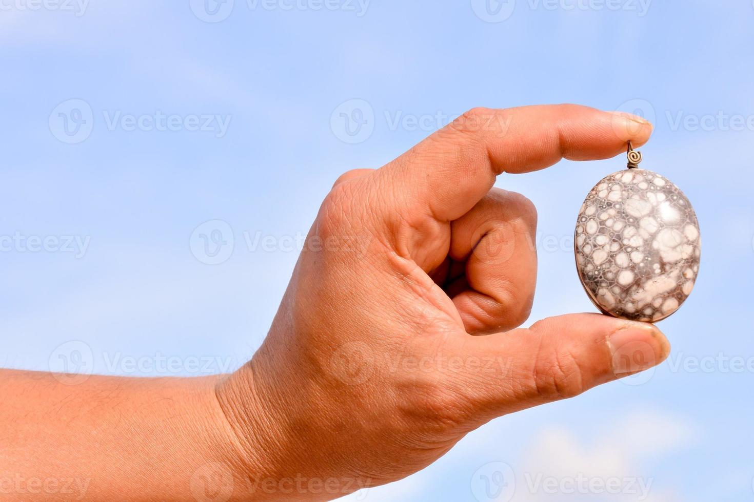 Hand holding a gemstone photo