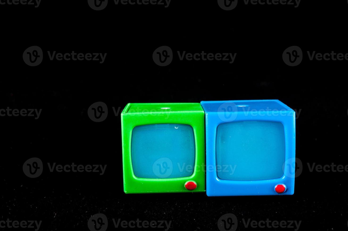 Toy televisions on black backround photo