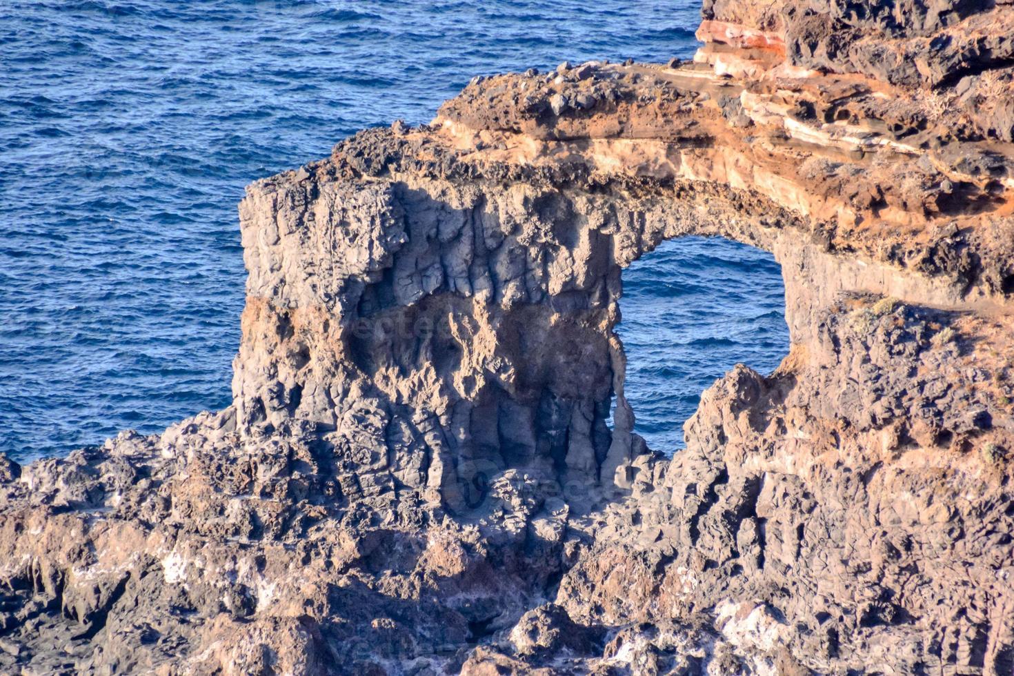 Natural rock arch by the sea photo
