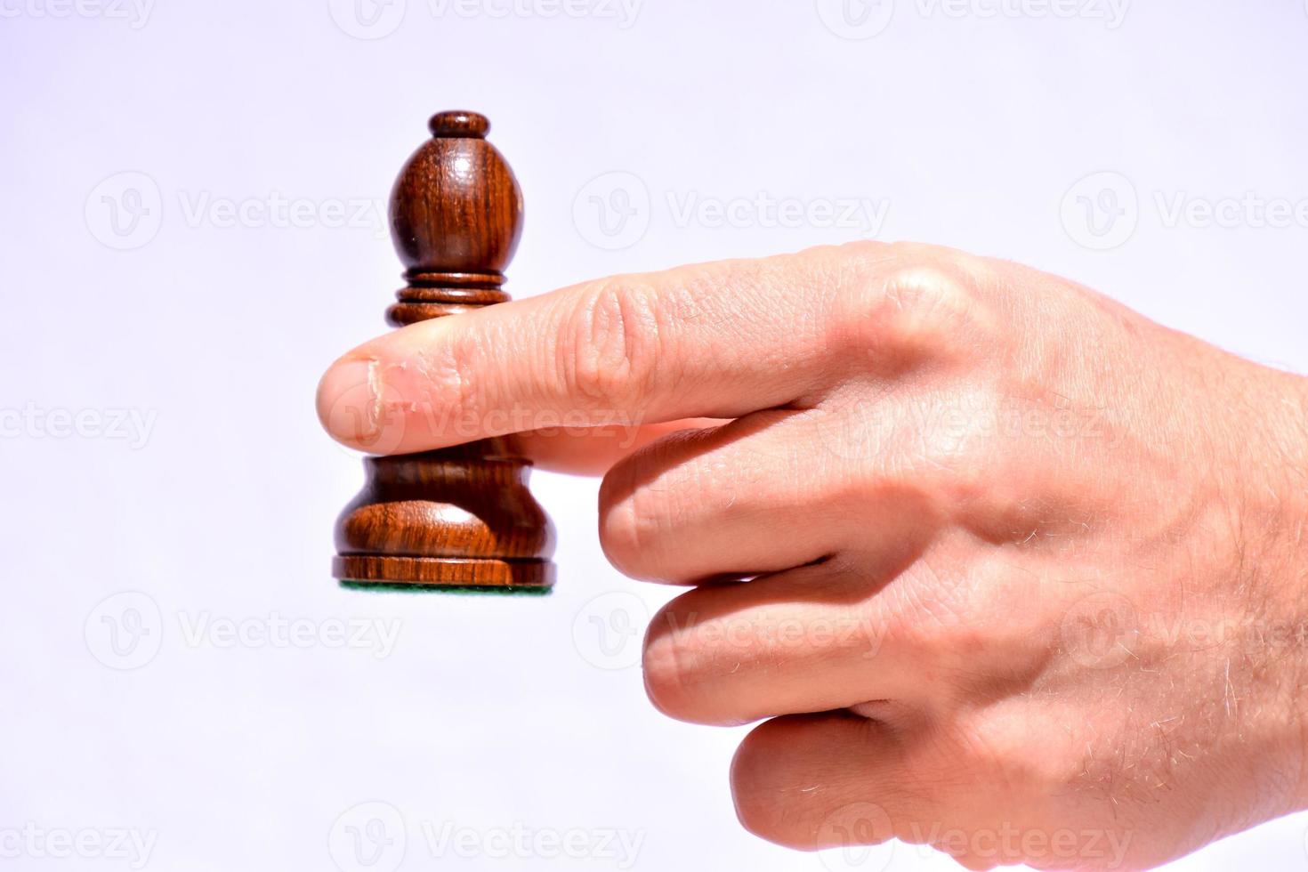 Hand holding a chess piece photo