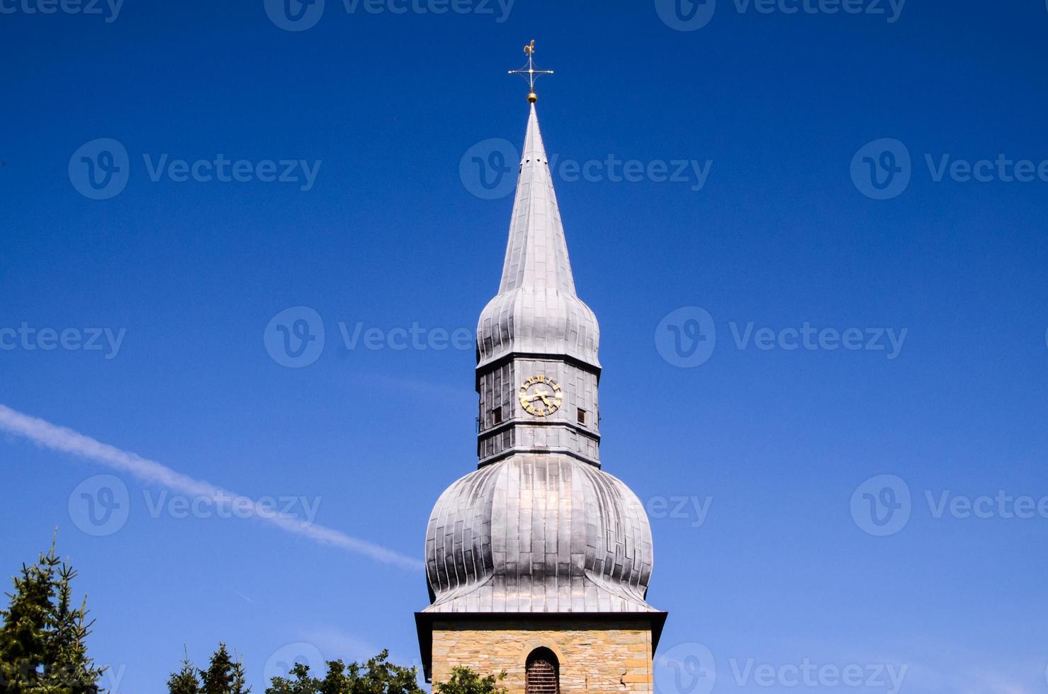 Steeple and blue sky photo