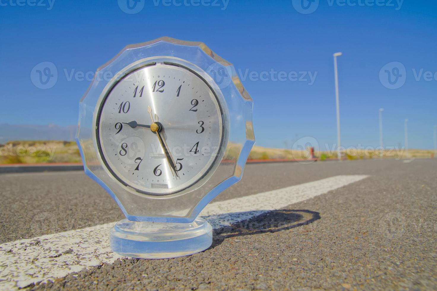 Clock on the road photo