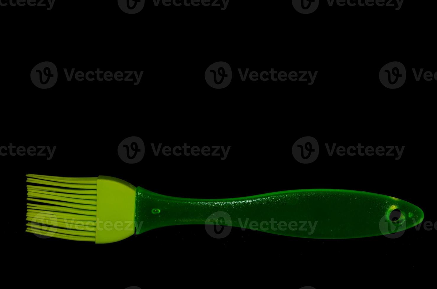 Green brush on black background photo