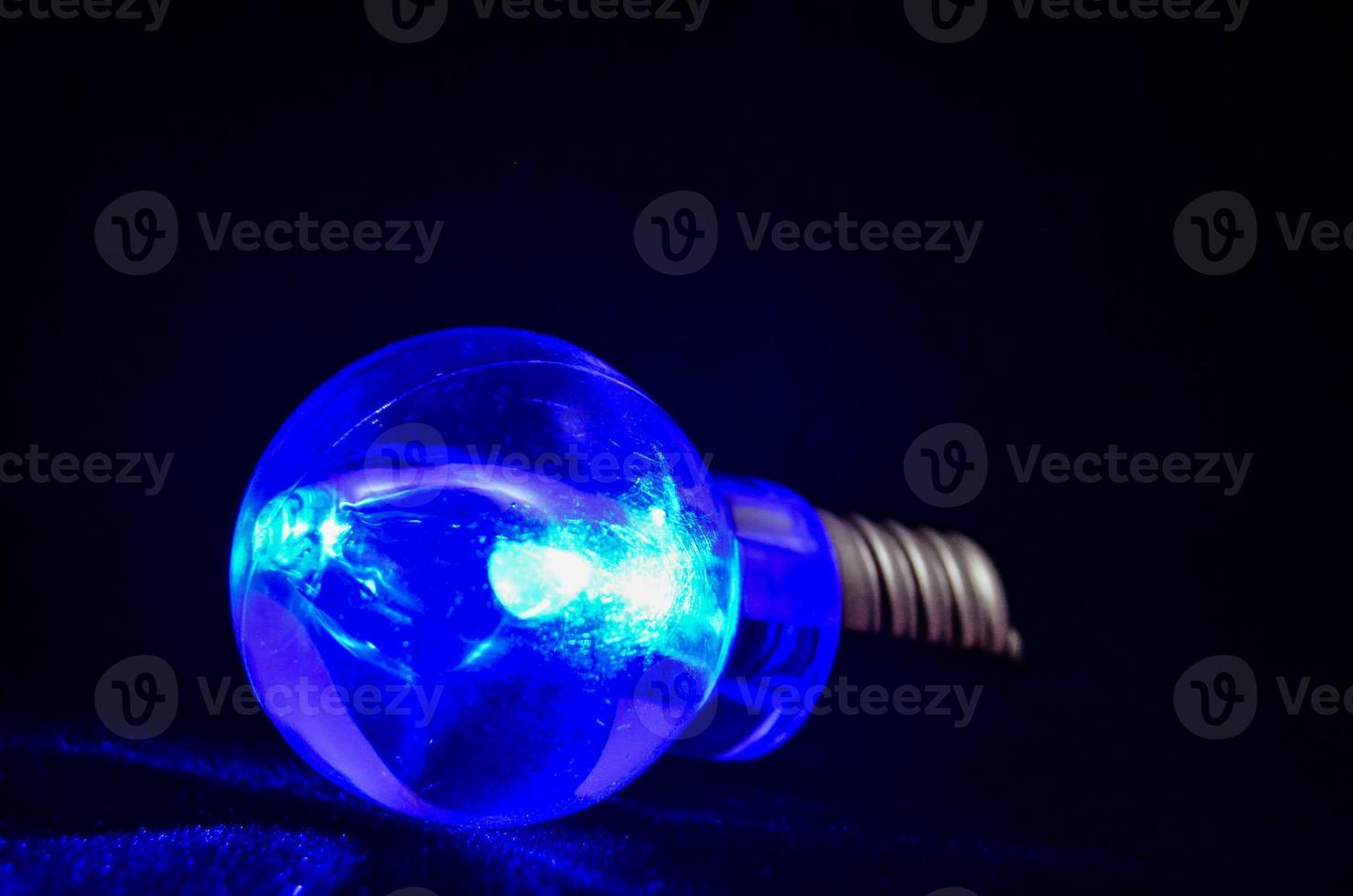 Blue light bulb on black background 19563437 Stock Photo at Vecteezy
