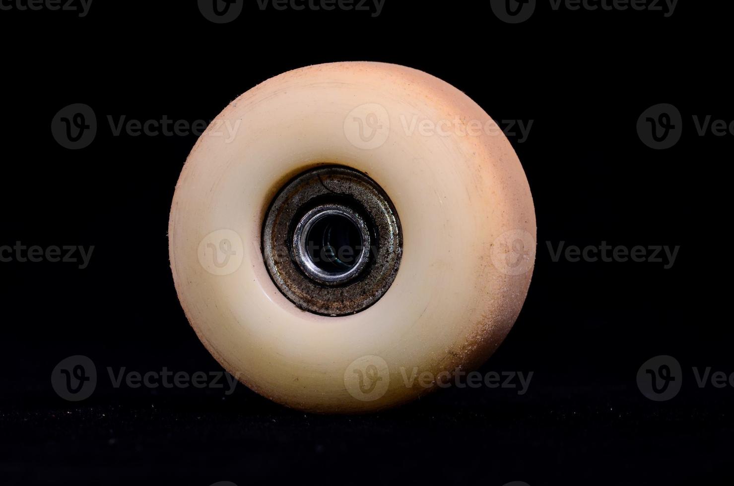 Skateboard wheel on black background photo