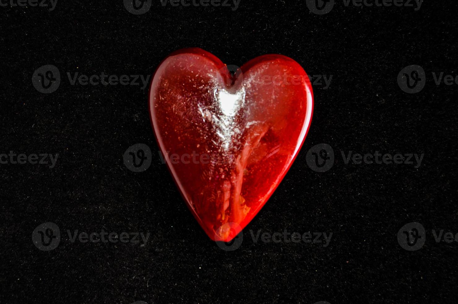 Red heart on black background photo