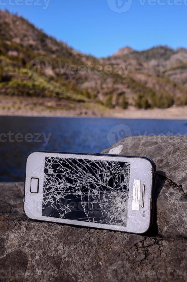 Broken phone on a rock photo