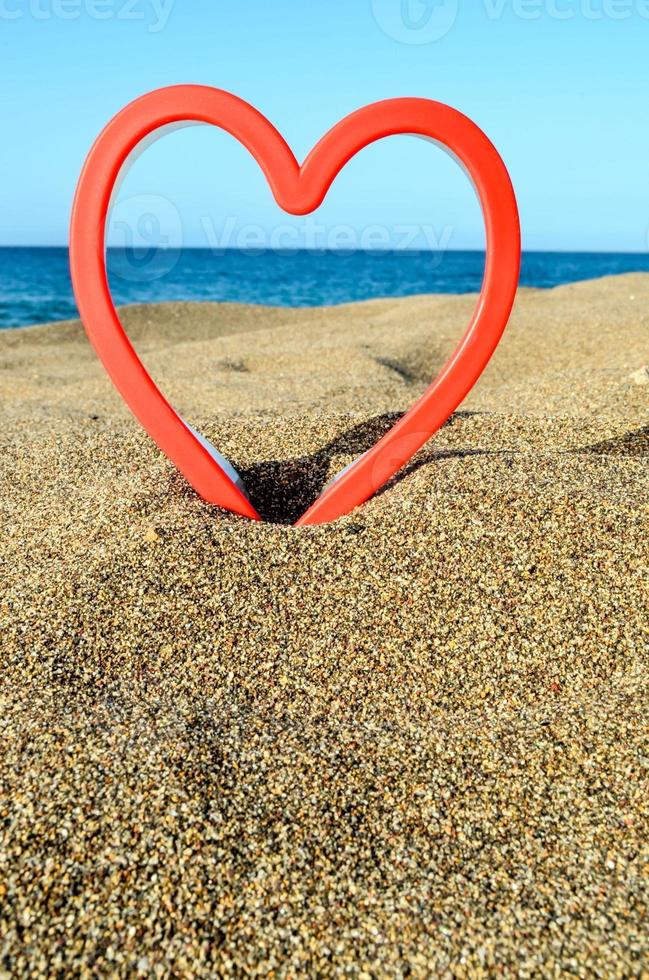 Red heart at the beach photo