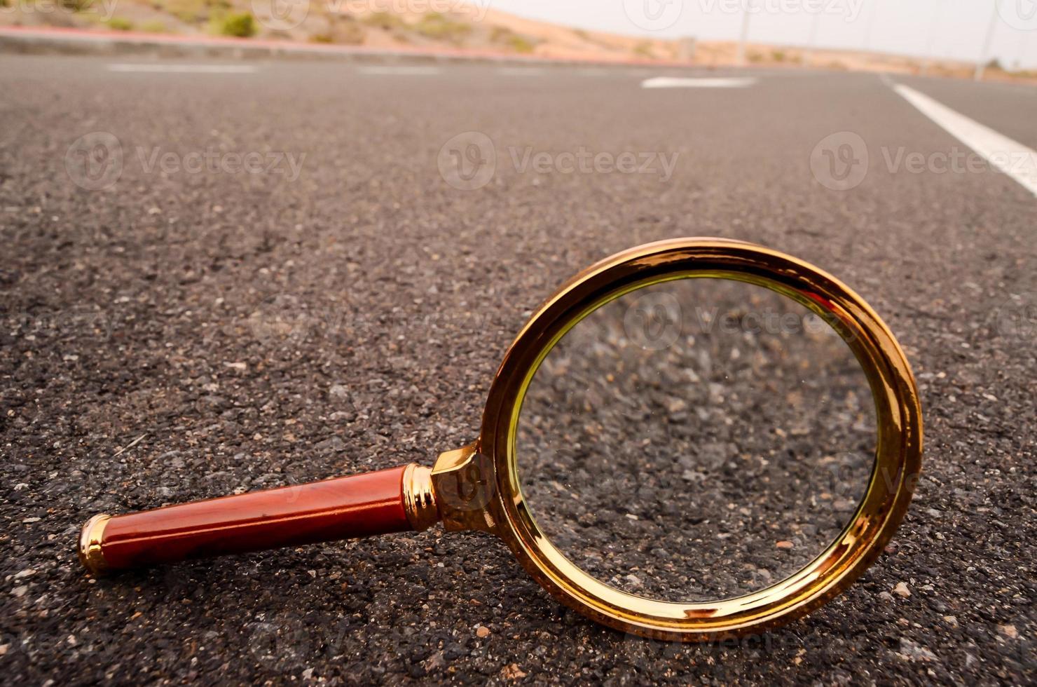 Magnifying glass on the road photo