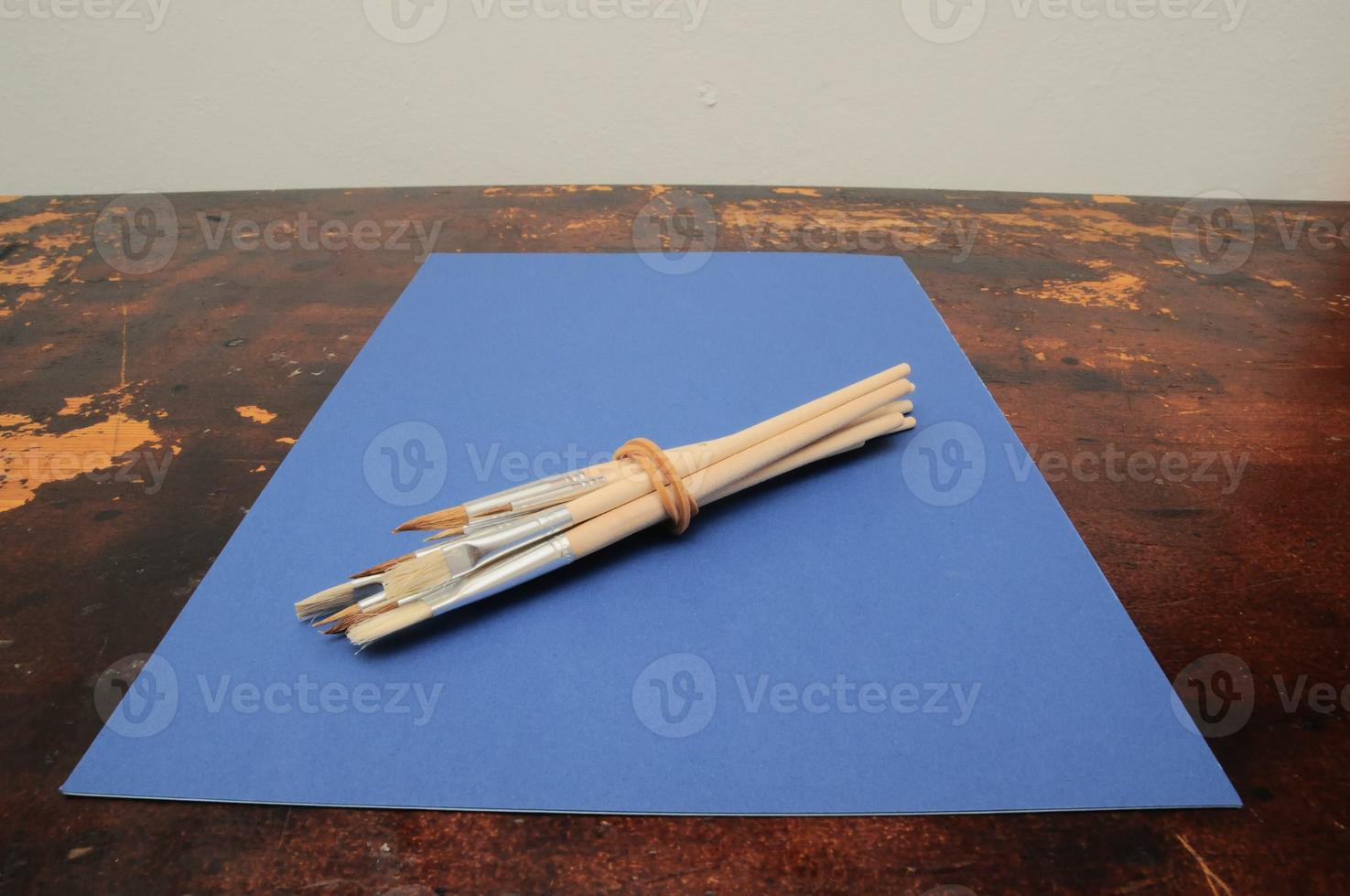 Paintbrushes on a blue paper photo