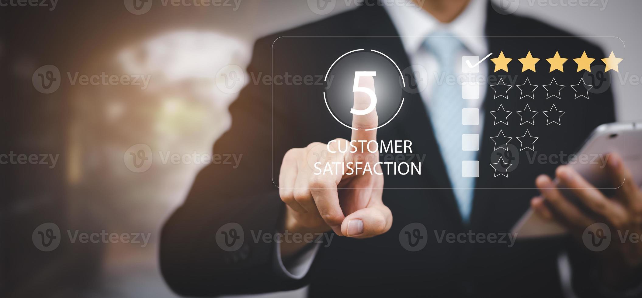 Businessman hold smartphone with Customer review satisfaction feedback survey concept, User give rating to service experience on online application, service leading to reputation ranking of business. photo