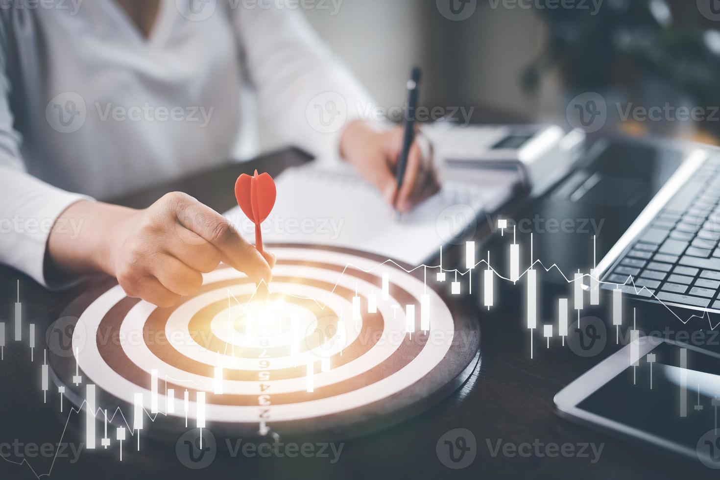 Targeting with marketing business concept, Businesswoman hand holding red dart to the virtual target dartboard, Executive marketing, investment goal and target for business investment concept, photo
