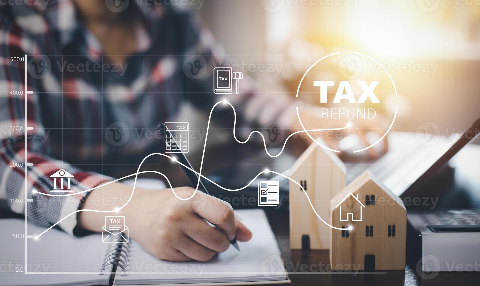 Concept tax payment optimisation business finance, wooden home  with taxes icon on technology screen, income tax and property, business individuals and corporations such as VAT photo