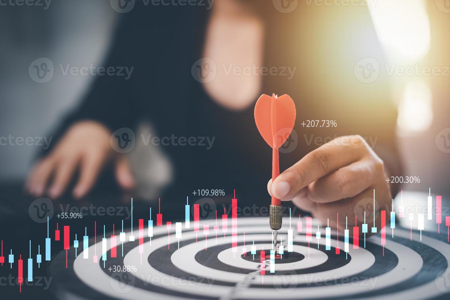 Targeting the business concept, Businesswoman hand holding red dart to the virtual target dartboard, Executive marketing, investment goal and target for business investment concept, photo