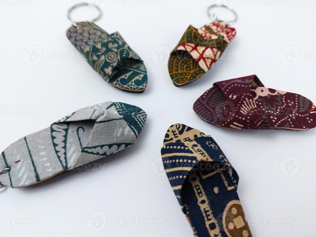 a miniature sandal with a batik motif on a white background photo