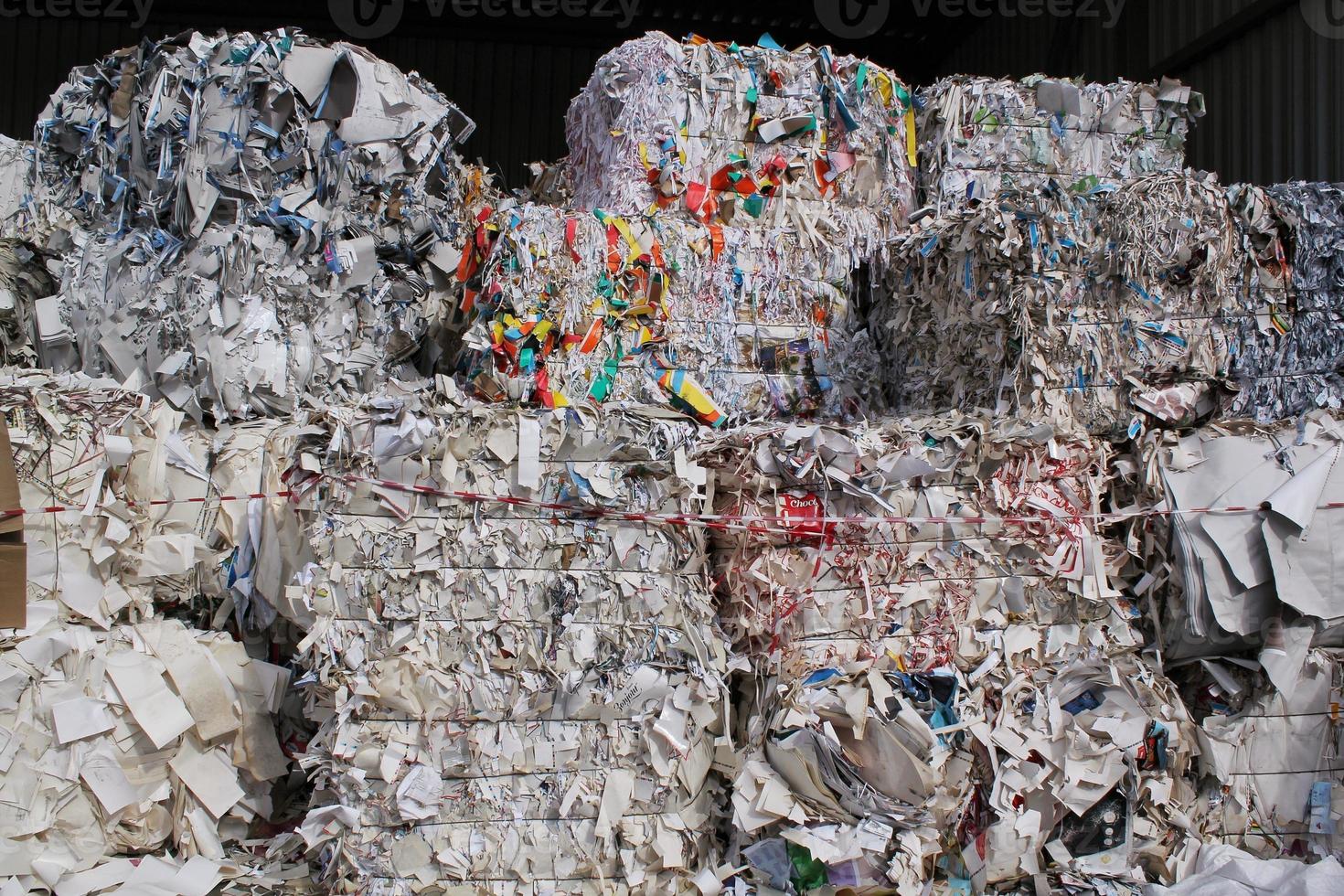 Wastepaper compact texture pile for recycling on sorting plant. Technology of reuse materials. Stack of shredded paper. Save the planet ecology concept. Industry of reduced pollution factory. Close-up photo