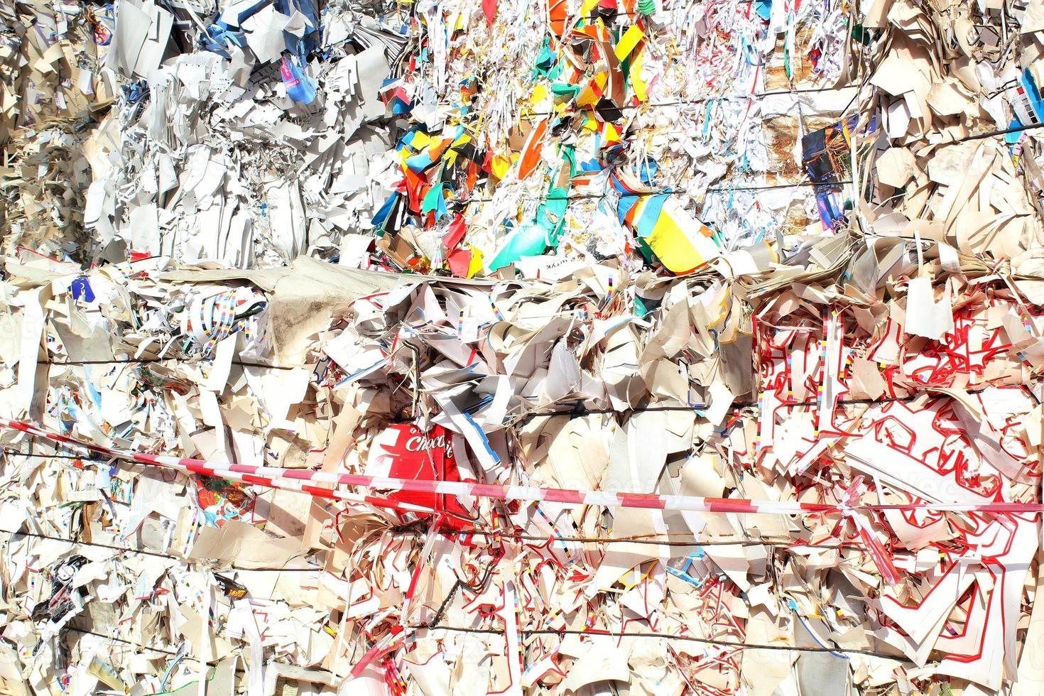 Wastepaper compact texture pile for recycling on sorting plant. Technology of reuse materials. Stack of shredded paper. Save the planet ecology concept. Industry of reduced pollution factory. Close-up photo