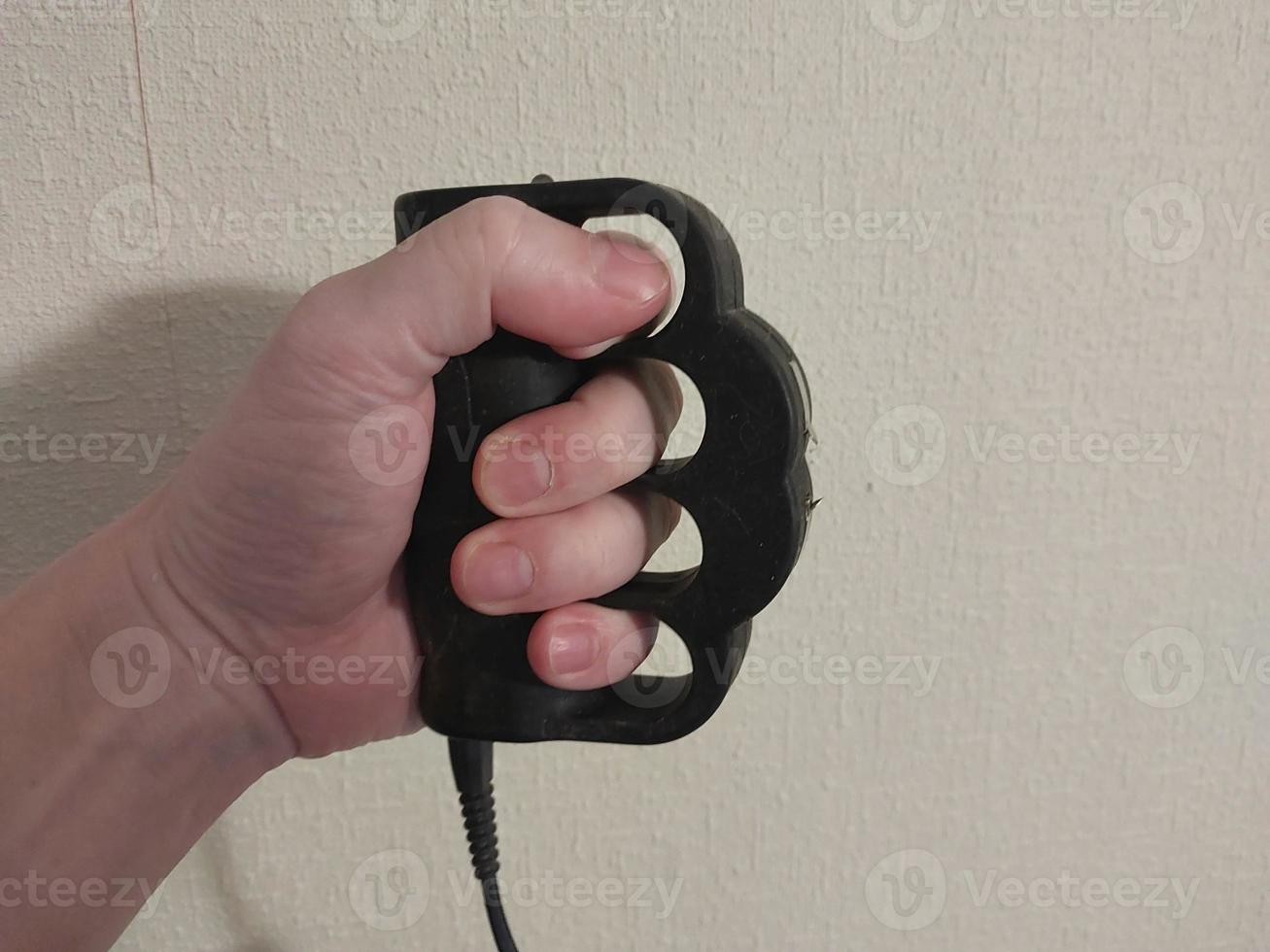 Taser brass knuckles for self-defense and defense photo