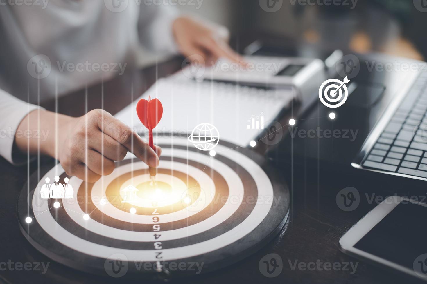 Targeting with marketing business concept, Businesswoman hand holding red dart to the virtual target dartboard, Executive marketing, investment goal and target for business investment concept, photo