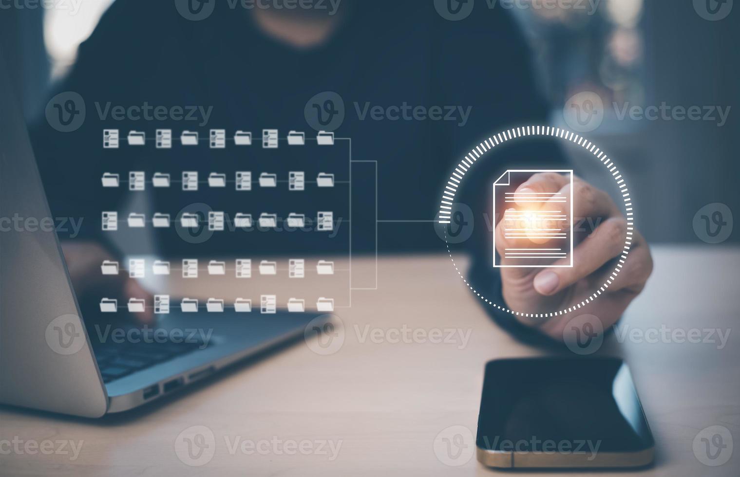 Businessman working on laptop and touch screen Online documentation database, IT consultant being set up Virtual Document Management System with laptop,Software for archiving corporate files. photo