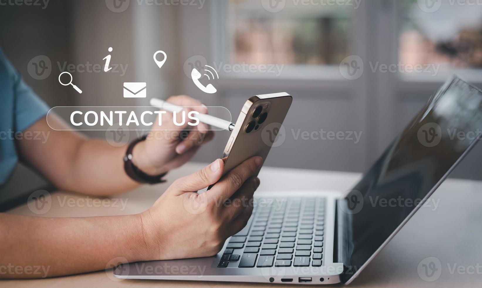 Communication and Contact us or Customer support hotline people connect. Hand using a laptop and touching on virtual screen contact icons, email and address, live chat with internet wifi. photo