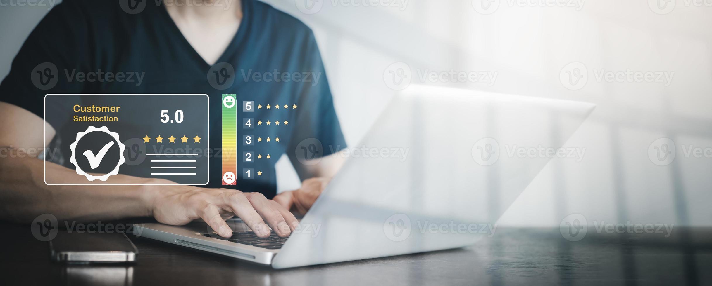 Man using laptop with Customer review satisfaction feedback survey concept, Customer review with feedback survey ,The concept of consumer reviews with review people icon with smartphone reviews. photo