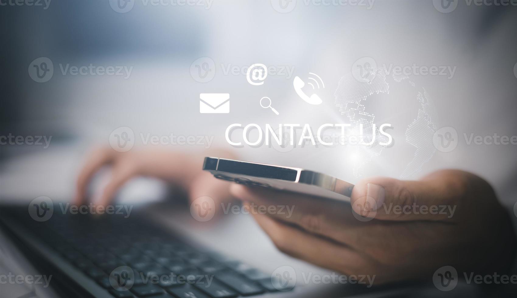 Communication and Contact us or Customer support hotline people connect. Hand using a laptop and touching on virtual screen contact icons, email and address, live chat with internet wifi. photo