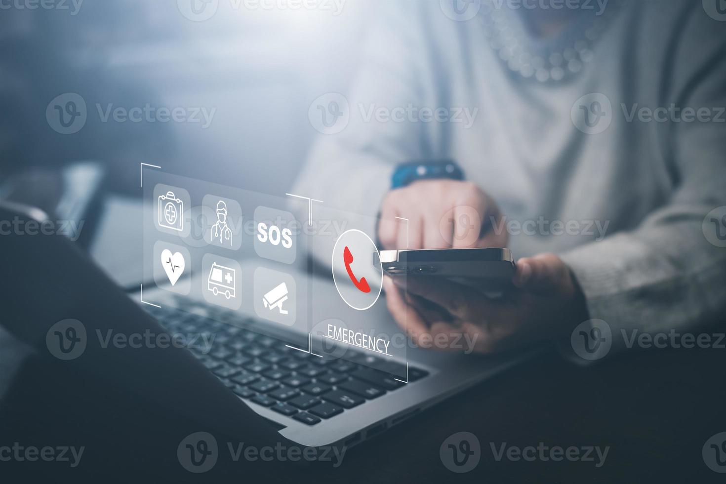 Man hand hold smartphone SOS Emergency app in home, call phone, Chat message icon, Emergency application from smartphone for elderly, technology concept.Old hand touch mobile phone and call for help. photo