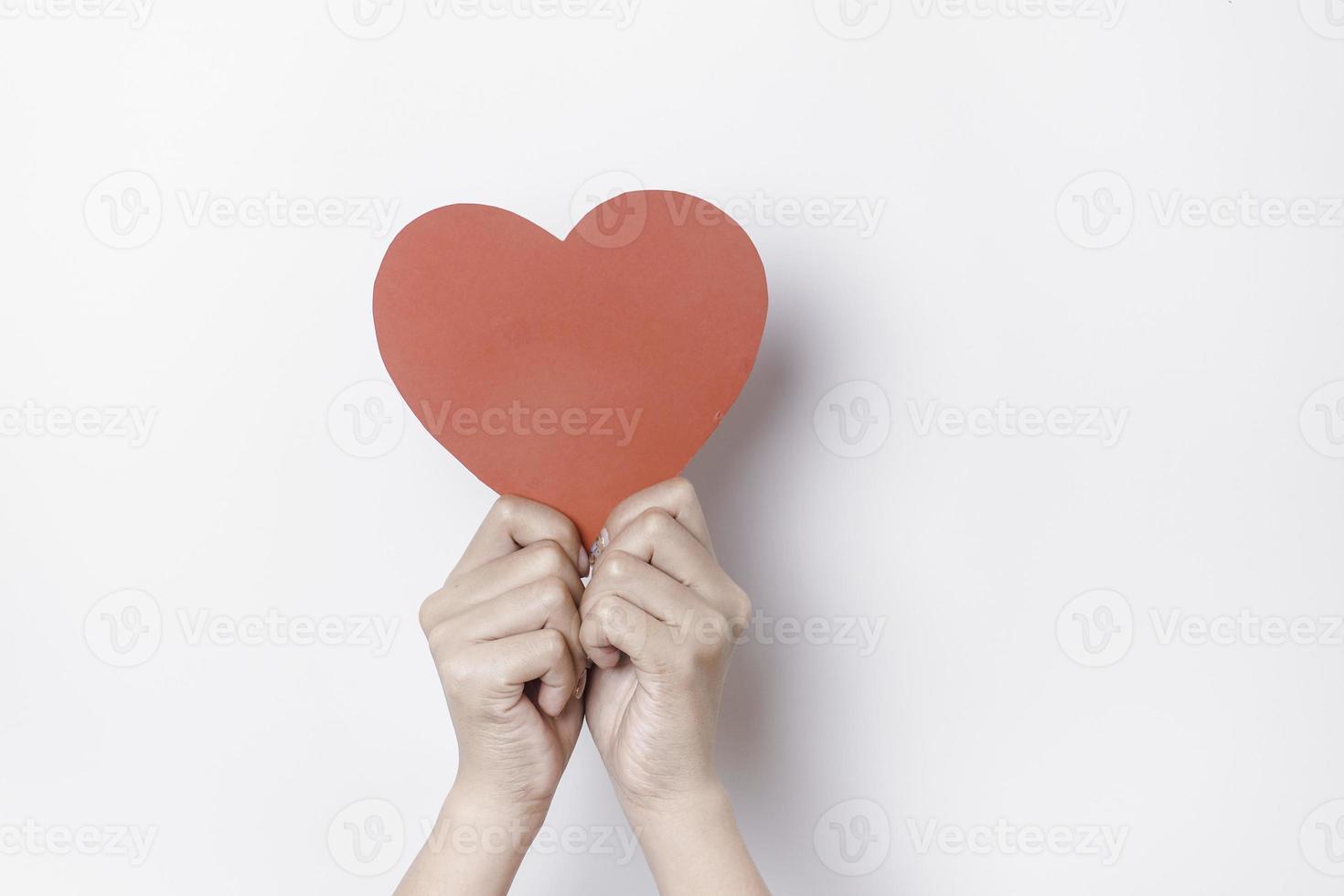 A photo of a red heart shape paper isolated on white background.