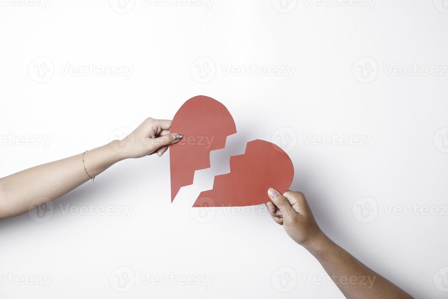 Close up of paper broken heart isolated on white background photo