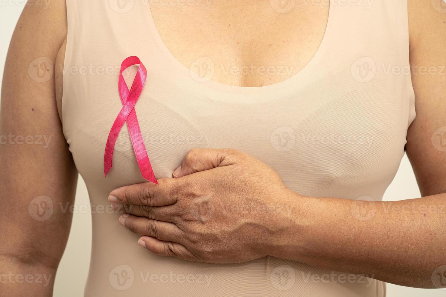 Breast cancer, pink ribbon at Asian senior lady for supporting awareness, symbol of World Breast Cancer Day. photo