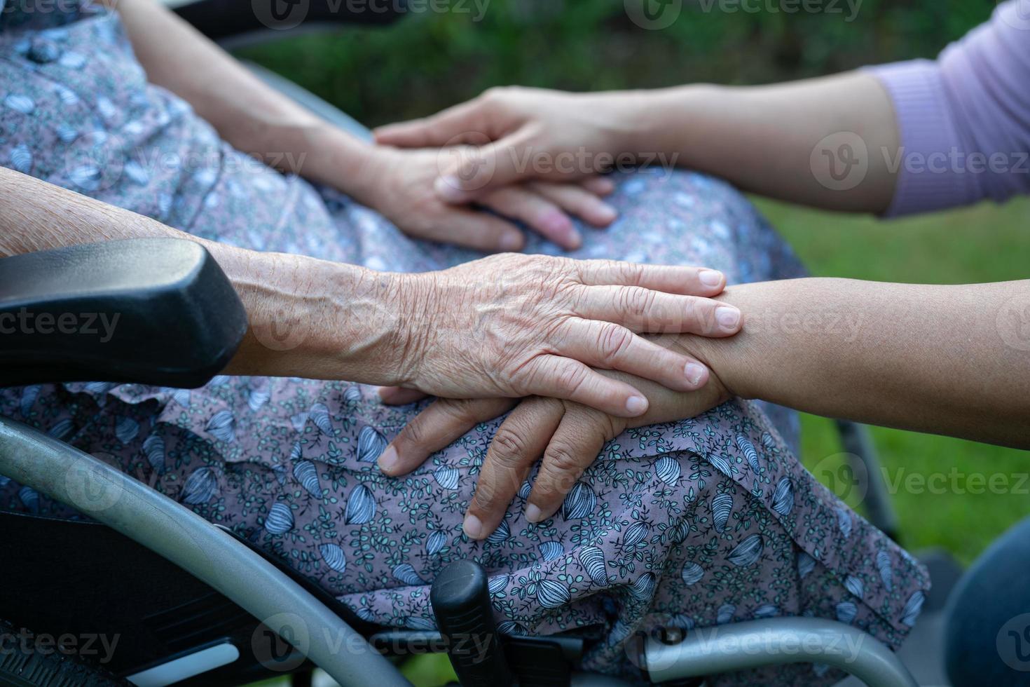 Holding hands Asian senior or elderly old lady woman patient with love, care, encourage and empathy at nursing hospital ward, healthy strong medical concept photo